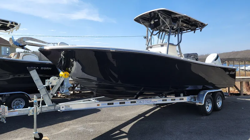 The Image of 2022 Sea Born LX24 Center Console boat on a trailer. - 0