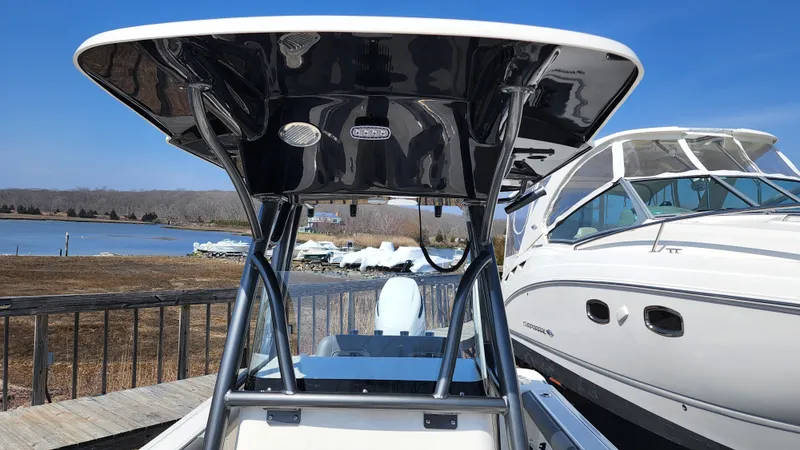 Slide: The Image of 2022 Sea Born LX24 Center Console boat docked near other boats. - 10