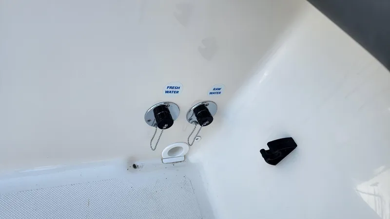 Slide: The Image of Fresh and raw water inlets on 2022 Sea Born LX24 Center Console boat. - 12