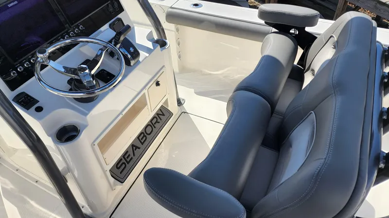 Slide: The Image of 2022 Sea Born LX24 Center Console boat interior with steering wheel and seating. - 14