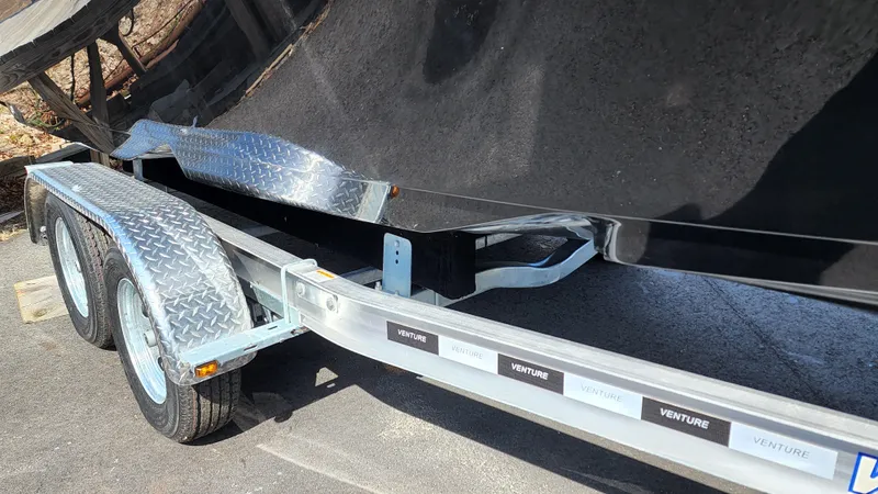 Slide: The Image of 2022 Sea Born LX24 Center Console boat on a Venture trailer. - 21