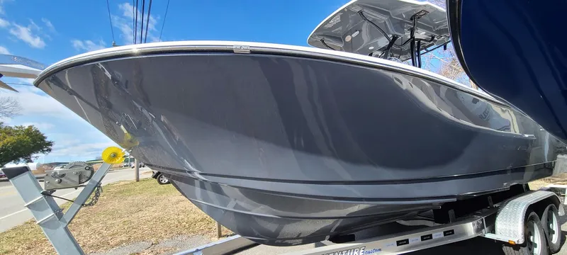 Slide: The Image of 2023 Sea Born SX239 Offshore boat on a trailer under a clear blue sky. - 2