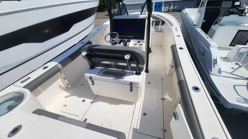 Slide: The Image of 2023 Sea Born SX239 Offshore boat interior with center console and seating. - 23