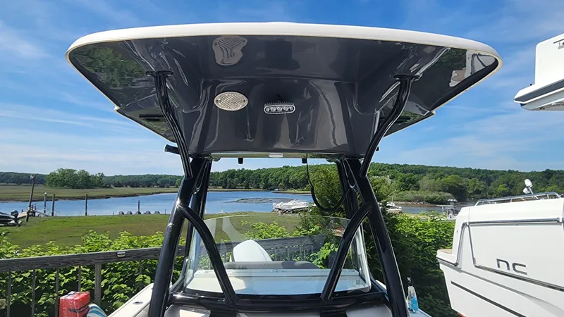 Slide: The Image of 2023 Sea Born SX239 Offshore boat with T-top, docked near a scenic waterfront. - 33