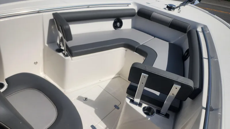Slide: The Image of 2023 Sea Born SX239 Offshore boat interior with cushioned seating and cup holders. - 34