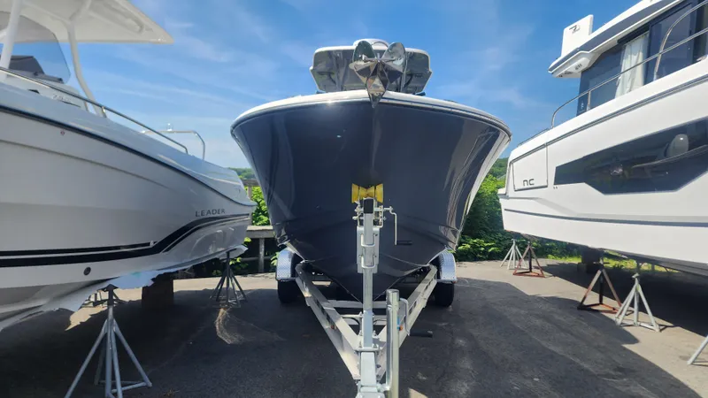 Slide: The Image of 2023 Sea Born SX239 Offshore boat on trailer between two other boats. - 43