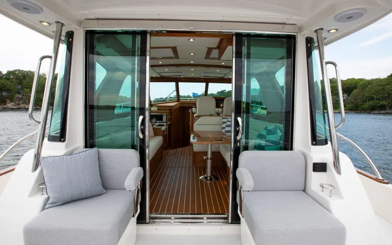 Slide: The Image of 2025 Sabre 43 Salon Express yacht interior with sliding glass doors and seating. - 10