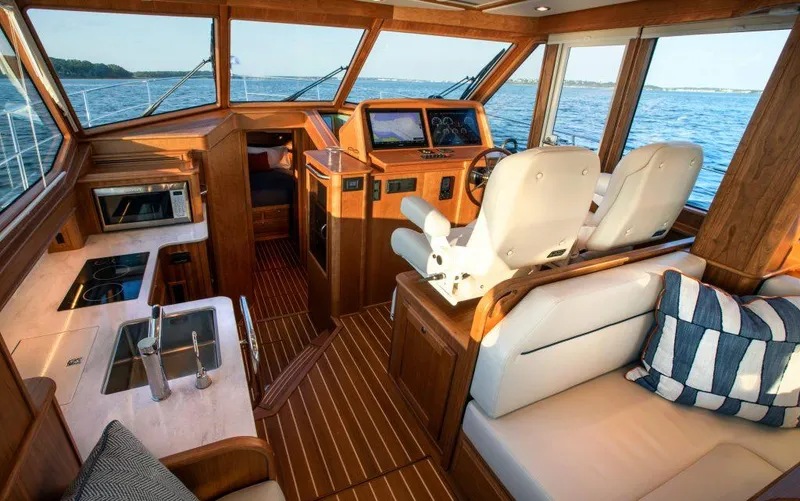 Slide: The Image of Interior of 2025 Sabre 43 Salon Express yacht with modern kitchen and helm. - 16