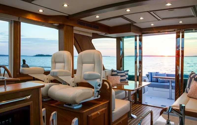 Slide: The Image of Interior of 2025 Sabre 43 Salon Express yacht with ocean view at sunset. - 17