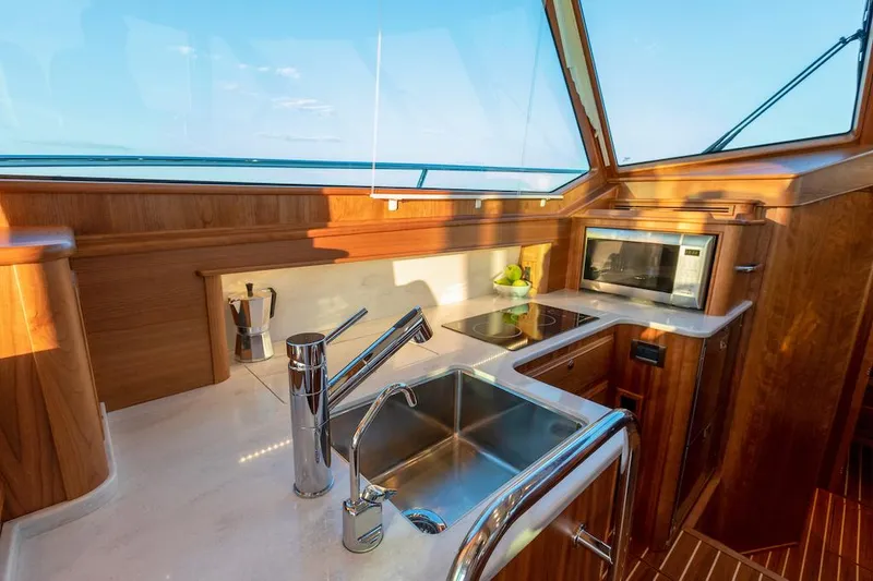 Slide: The Image of Modern kitchen area in 2025 Sabre 43 Salon Express yacht with stainless steel sink and appliances. - 19