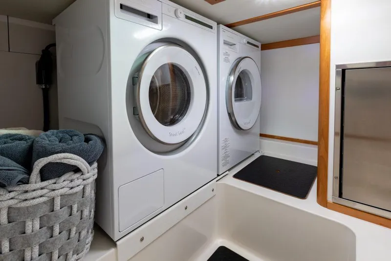 Slide: The Image of Laundry area with washer and dryer in 2025 Sabre 43 Salon Express yacht. - 34