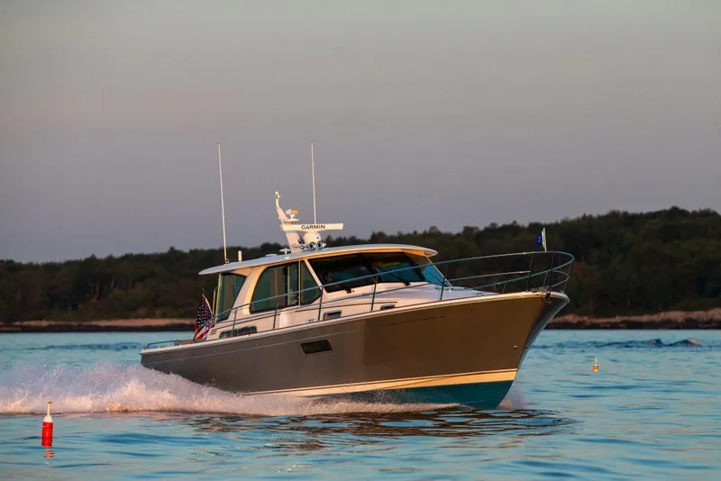 Slide: The Image of 2025 Sabre 43 Salon Express cruising on water at sunset. - 4