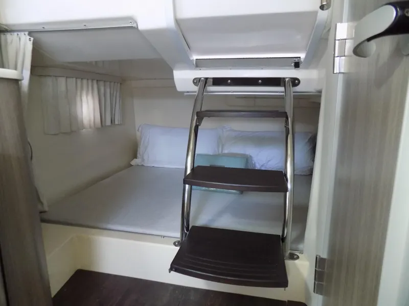 Slide: The Image of 2019 Regal 28 Express cabin interior with bed and ladder. - 11