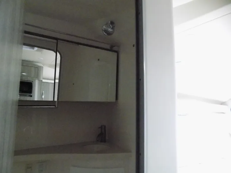 Slide: The Image of 2019 Regal 28 Express bathroom interior with mirror and sink. - 14