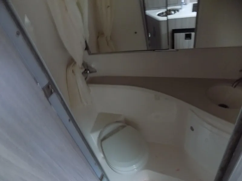 Slide: The Image of 2019 Regal 28 Express bathroom interior with toilet and sink. - 15