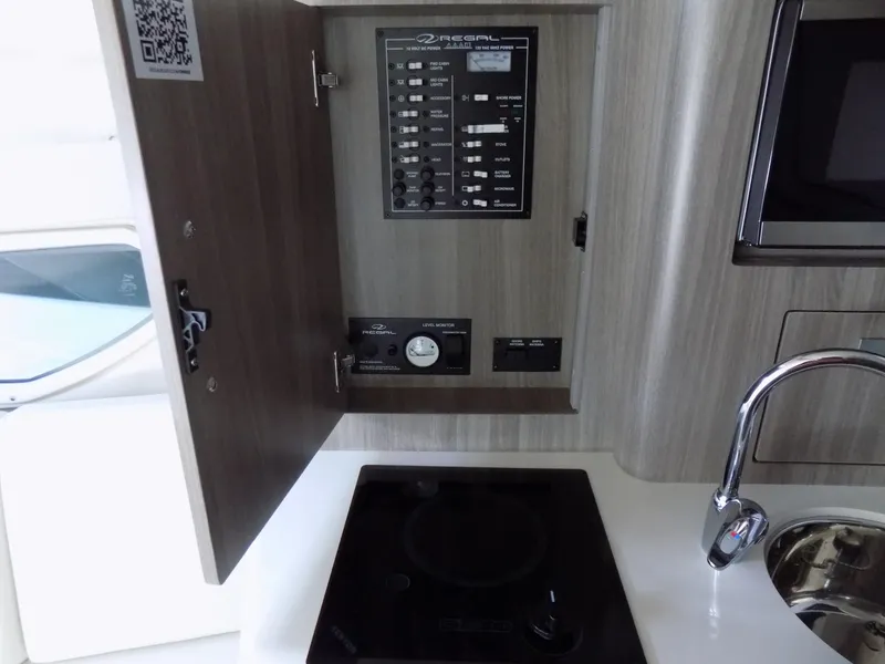 Slide: The Image of Control panel and kitchenette in 2019 Regal 28 Express boat interior. - 17
