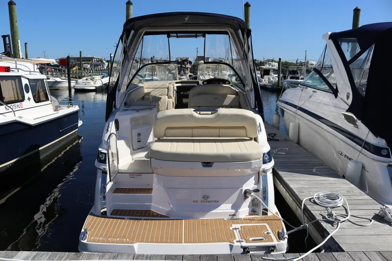Slide: The Image of 2019 Regal 28 Express boat docked at marina, featuring spacious seating and sleek design. - 19