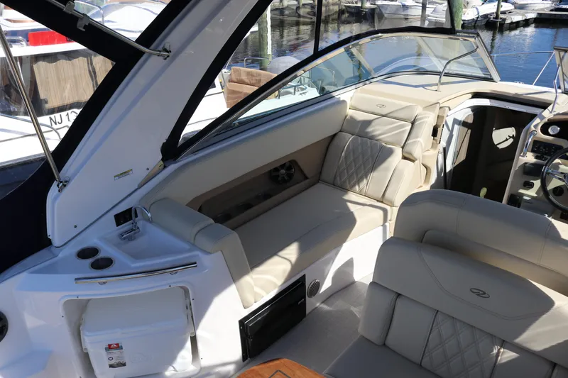 Slide: The Image of 2019 Regal 28 Express boat interior with beige seating and modern dashboard. - 22
