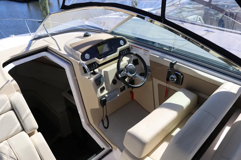 Slide: The Image of 2019 Regal 28 Express boat interior with steering wheel and control panel. - 23