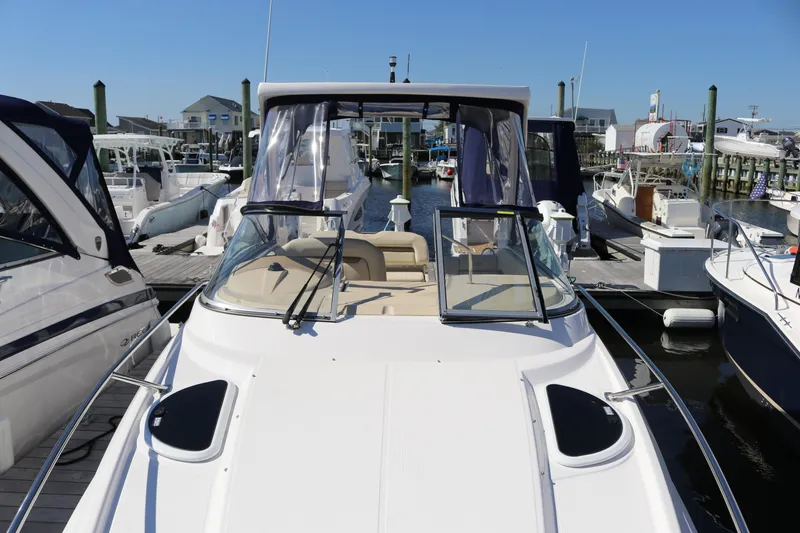 Slide: The Image of 2019 Regal 28 Express boat docked at a marina, showcasing sleek design and spacious deck. - 29