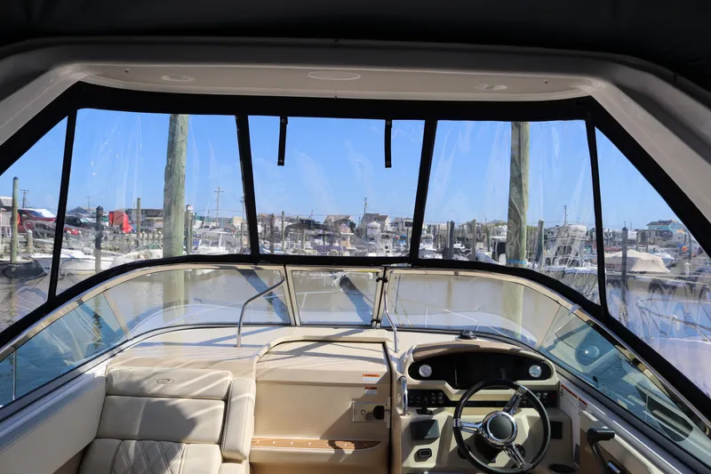 Slide: The Image of Interior view of 2019 Regal 28 Express boat cockpit with marina in background. - 30