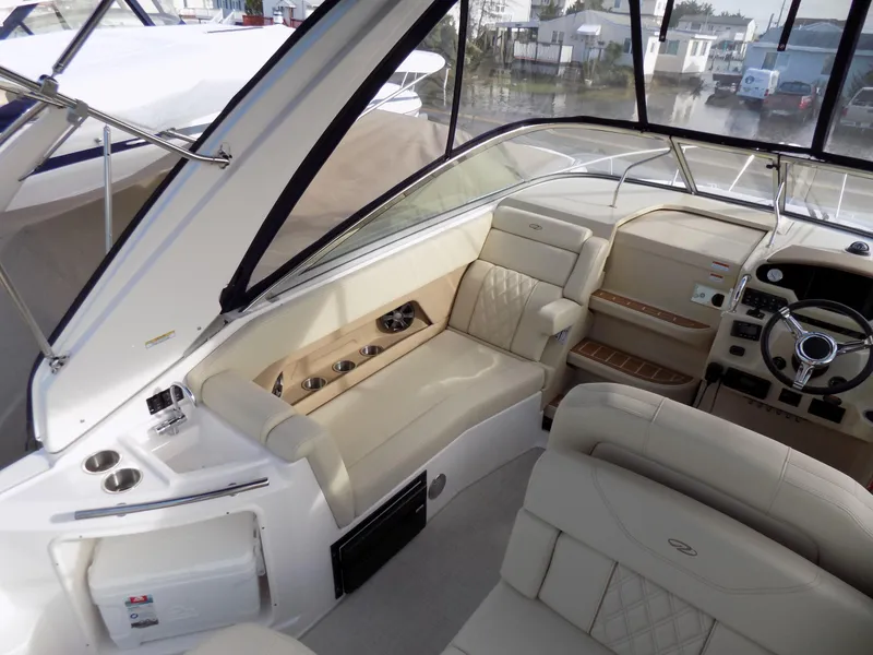 Slide: The Image of 2019 Regal 28 Express boat interior with beige seating and modern dashboard. - 6