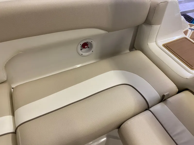 Slide: The Image of 2018 NauticStar 243DC Sport Deck beige and white cushioned seating. - 16