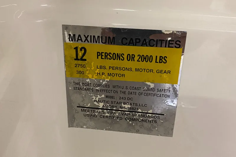 Slide: The Image of 2018 NauticStar 243DC Sport Deck maximum capacity label, 12 persons or 2000 lbs. - 23