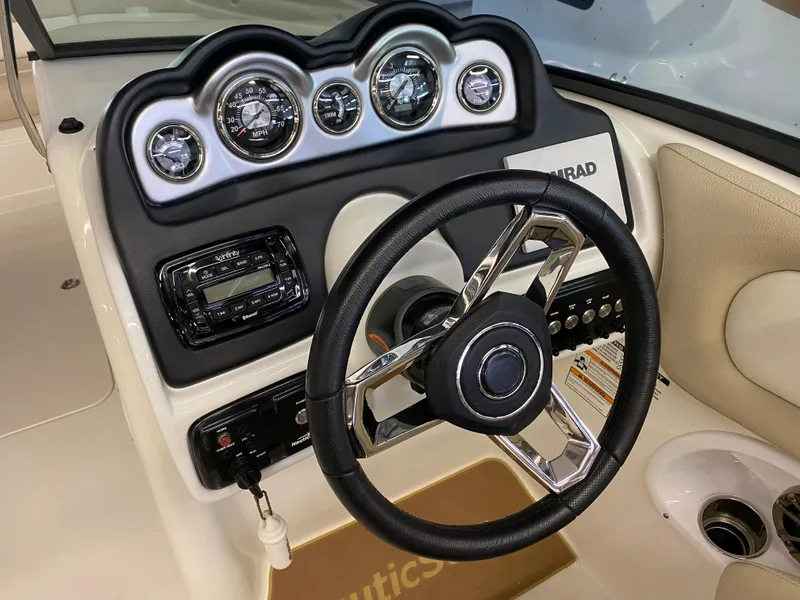 Slide: The Image of 2018 NauticStar 243DC Sport Deck dashboard with steering wheel and instrument panel. - 9