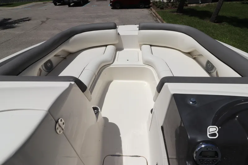Slide: The Image of 2018 Bayliner 210 DB boat interior with white seating and gray accents. - 11