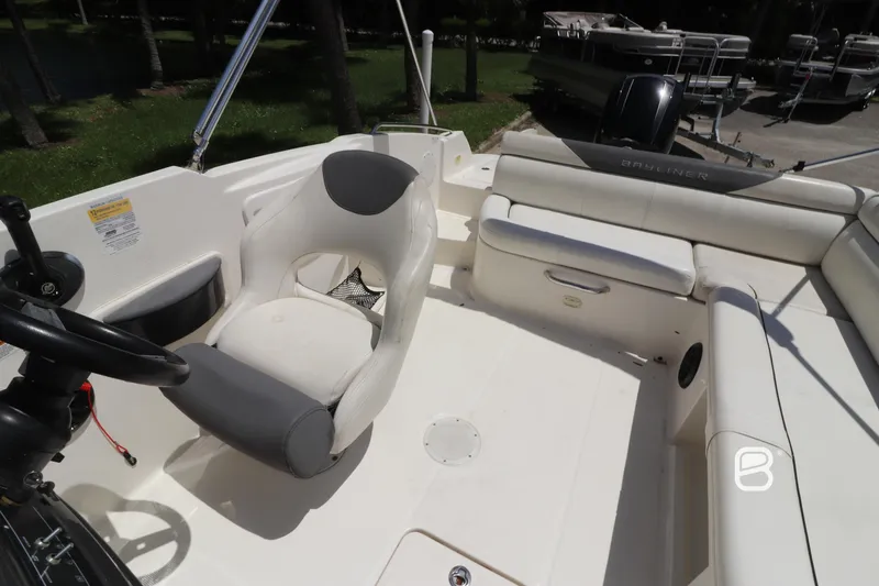 Slide: The Image of 2018 Bayliner 210 DB boat interior with seating and steering wheel. - 14