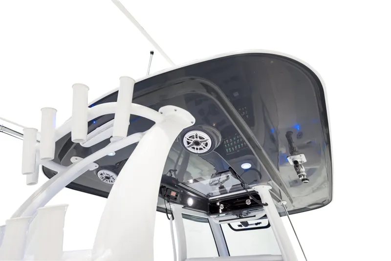 Slide: The Image of 2024 Sportsman 322 OPEN CC boat console with T-top and rod holders. - 10