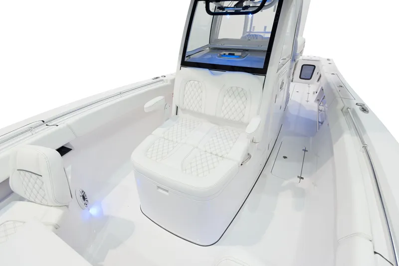 Slide: The Image of 2024 Sportsman 322 OPEN CC INCOMING boat interior with white seating and modern design. - 21