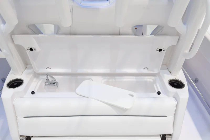 Slide: The Image of 2024 Sportsman 322 OPEN CC boat interior storage compartment with cup holders. - 22