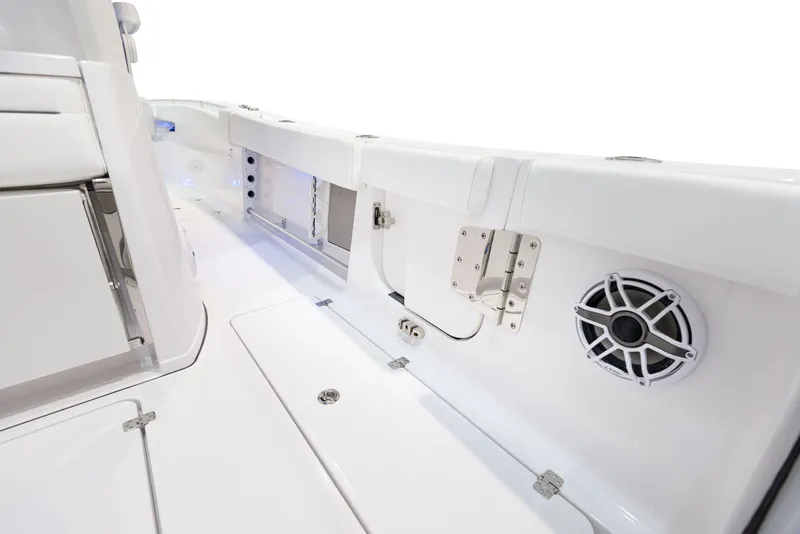 Slide: The Image of 2024 Sportsman 322 OPEN CC boat interior with white deck and built-in speaker. - 24