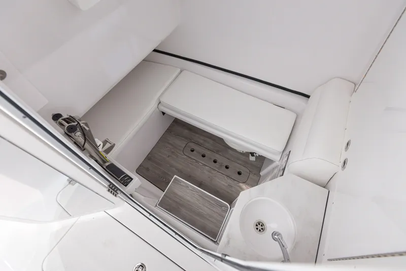 Slide: The Image of 2024 Sportsman 322 OPEN CC boat interior with seating and sink. - 27