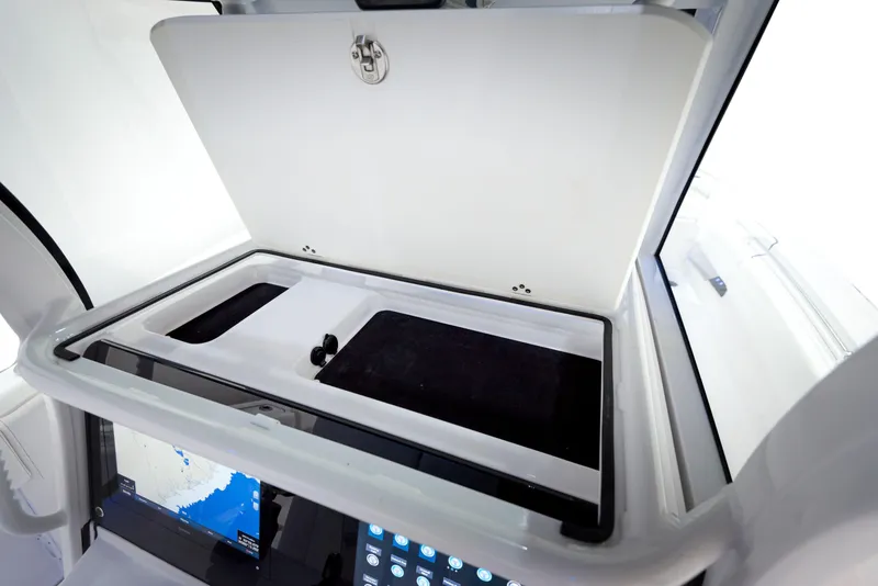 Slide: The Image of 2024 Sportsman 322 OPEN CC INCOMING boat console with open storage compartment. - 9