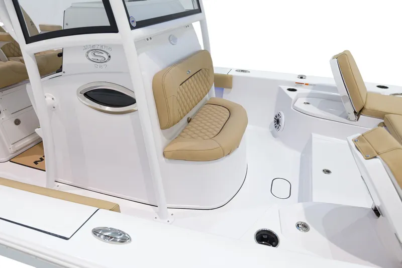 Slide: The Image of 2024 Sportsman Masters 267 Bay Boat interior with tan seating and white deck. - 17