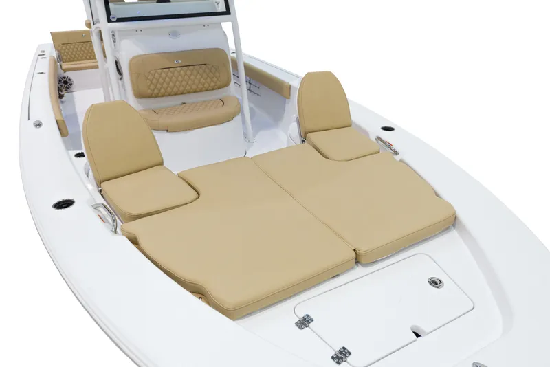 Slide: The Image of 2024 Sportsman Masters 267 Bay Boat with tan cushioned seating and white deck. - 19