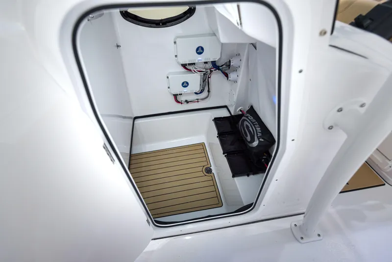 Slide: The Image of 2024 Sportsman Masters 267 Bay Boat interior storage compartment with electrical components. - 21