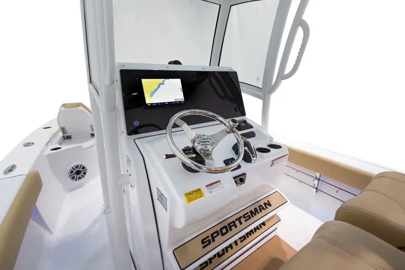 Slide: The Image of 2024 Sportsman Masters 267 Bay Boat helm with navigation display and steering wheel. - 3