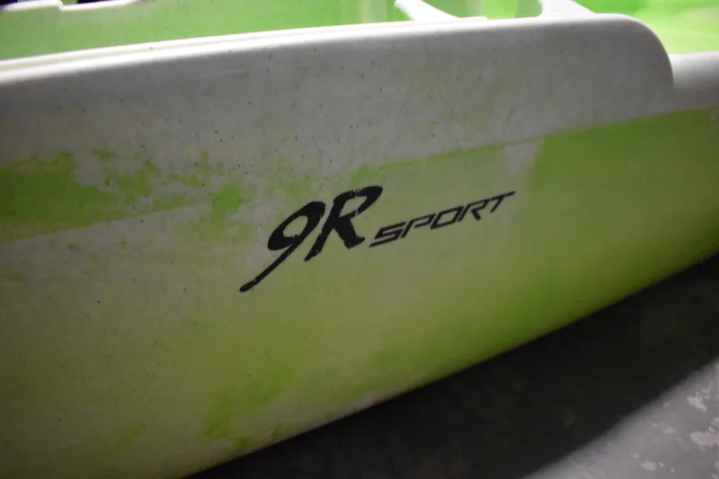 Slide: The Image of Close-up of 2021 Ascend 9R Sport Sit-On kayak with green and white design. - 15