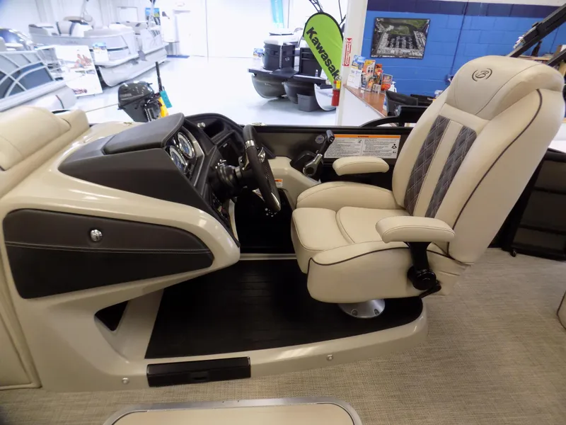 Slide: The Image of 2023 Barletta L23UC boat interior with captain's chair and control panel. - 10