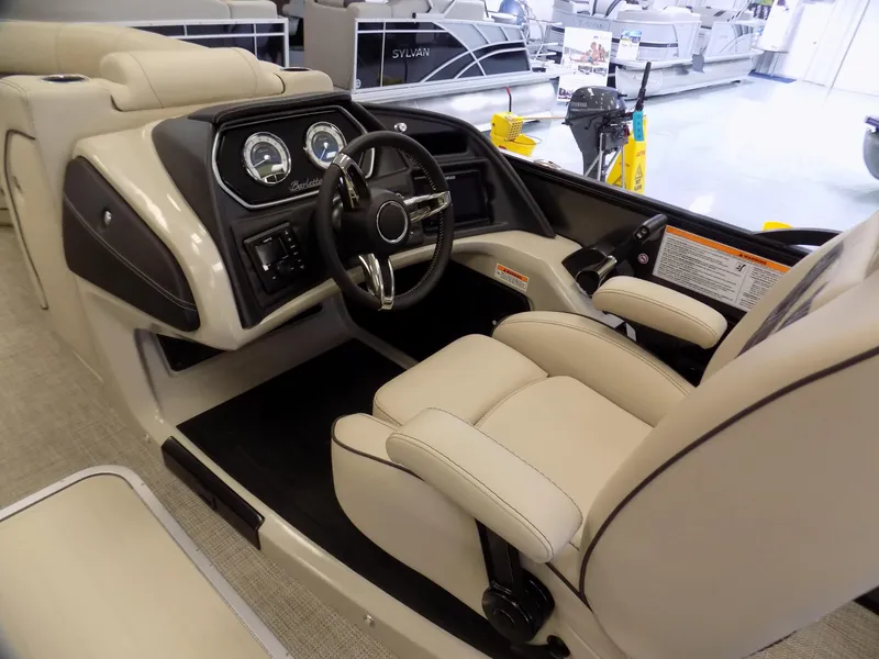Slide: The Image of 2023 Barletta L23UC boat interior with beige seating and modern dashboard controls. - 11