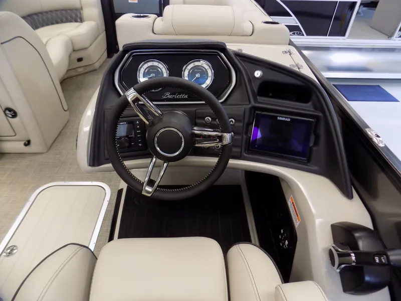 Slide: The Image of 2023 Barletta L23UC boat dashboard with steering wheel and control panel. - 12