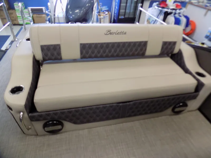 Slide: The Image of 2023 Barletta L23UC boat seating with beige and gray upholstery, featuring cup holders. - 13