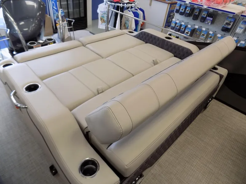 Slide: The Image of 2023 Barletta L23UC pontoon boat interior with beige seating and cup holders. - 14