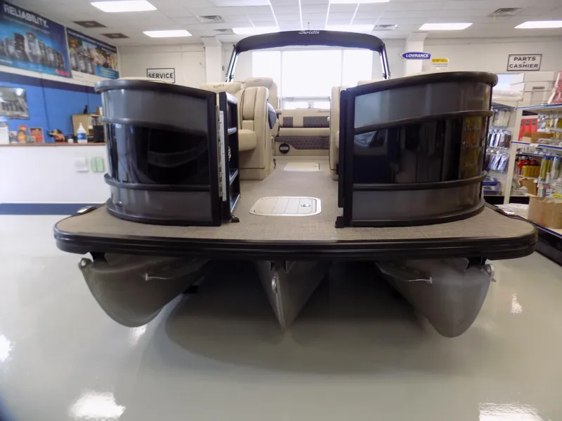 Slide: The Image of 2023 Barletta L23UC pontoon boat displayed in showroom, front view. - 3