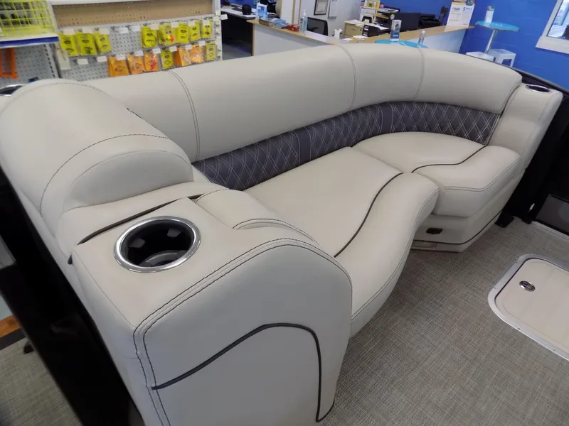 Slide: The Image of 2023 Barletta L23UC boat interior with plush seating and cup holder. - 6