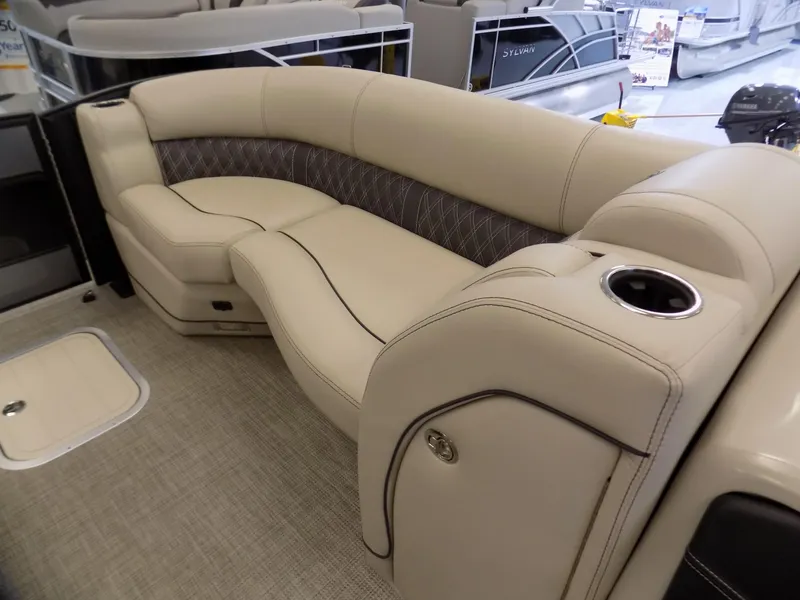 Slide: The Image of Luxurious seating on 2023 Barletta L23UC pontoon boat with beige upholstery and cup holder. - 7